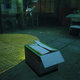 A cat hides in a box in Stray.